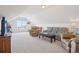 Bright bonus room featuring vaulted ceilings, comfortable seating, and plush carpeting at 16665 Kenuil St, Brighton, CO 80603
