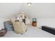 Spacious bonus room with cozy seating, wood furnishings, and bright, neutral paint at 16665 Kenuil St, Brighton, CO 80603