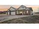 Charming two-story home with a brick accent, a spacious three-car garage, and a beautifully landscaped front yard at 16665 Kenuil St, Brighton, CO 80603