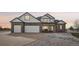 Charming two-story home with a brick accent, a spacious three-car garage, and a beautifully landscaped front yard at 16665 Kenuil St, Brighton, CO 80603
