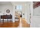 Bright foyer featuring hardwood floors, an elegant staircase, and stylish decor, creating a welcoming entrance at 16665 Kenuil St, Brighton, CO 80603