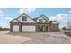 Charming two-story home with a three-car garage and beautifully landscaped front yard at 16665 Kenuil St, Brighton, CO 80603