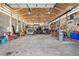 Large garage with high ceilings and exposed rafters, ample space for multiple vehicles and storage at 16665 Kenuil St, Brighton, CO 80603