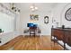 Bright home office featuring hardwood floors, natural light, and elegant decor at 16665 Kenuil St, Brighton, CO 80603