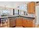 Open kitchen with stainless steel appliances, granite countertops, and a seamless transition to the dining area at 16665 Kenuil St, Brighton, CO 80603
