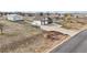 Aerial view of the home showcasing its large lot, attached garages, and convenient location at 16665 Kenuil St, Brighton, CO 80603
