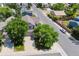 This aerial view captures a home with a spacious lot, mature trees, and a well-manicured lawn at 4997 Collinsville Pl, Highlands Ranch, CO 80130