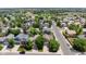 This aerial view showcases a neighborhood with mature trees, green spaces, and well-maintained homes at 4997 Collinsville Pl, Highlands Ranch, CO 80130