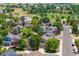 This aerial view showcases a neighborhood with mature trees, green spaces, and well-maintained homes at 4997 Collinsville Pl, Highlands Ranch, CO 80130