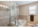 Bathroom with soaking tub, glass door and tile surround at 4997 Collinsville Pl, Highlands Ranch, CO 80130