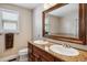 This bathroom features granite countertops, double sinks, and a large mirror at 4997 Collinsville Pl, Highlands Ranch, CO 80130