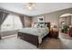 This spacious bedroom features a ceiling fan, a large window, and an en suite bathroom at 4997 Collinsville Pl, Highlands Ranch, CO 80130