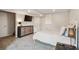 Neutral bedroom features a modern dresser, wall-mounted television and plush carpeting at 4997 Collinsville Pl, Highlands Ranch, CO 80130