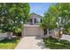 Charming two-story home with a well-manicured front yard and attached two-car garage at 4997 Collinsville Pl, Highlands Ranch, CO 80130