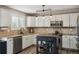 Well-lit kitchen with stainless steel appliances, an island, and ample counter space at 4997 Collinsville Pl, Highlands Ranch, CO 80130