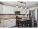 Modern kitchen featuring stainless steel appliances, a functional island, and stylish pendant lighting at 4997 Collinsville Pl, Highlands Ranch, CO 80130