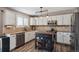 Updated kitchen with stainless steel appliances, a functional island, and bright lighting at 4997 Collinsville Pl, Highlands Ranch, CO 80130