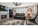 Cozy living room featuring a fireplace, plush seating, and a ceiling fan for comfort at 4997 Collinsville Pl, Highlands Ranch, CO 80130