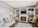 Inviting living room with a fireplace, built-in shelving, and cozy seating at 4997 Collinsville Pl, Highlands Ranch, CO 80130