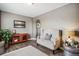 Comfortable sitting room featuring hardwood floors, area rug, and accent chair at 4997 Collinsville Pl, Highlands Ranch, CO 80130