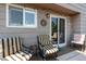 This covered patio features comfortable seating and string lights, perfect for outdoor entertaining at 4997 Collinsville Pl, Highlands Ranch, CO 80130