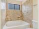 Bathroom with soaking tub and tiled walls at 72 S Nome St, Aurora, CO 80012