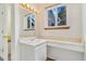 Well-lit bathroom vanity area with a sink, mirror, and window view at 72 S Nome St, Aurora, CO 80012