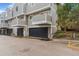 Townhome with attached garages, neutral siding, and private front balconies at 72 S Nome St, Aurora, CO 80012