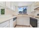 The kitchen features white appliances, cabinets, countertops, and a window view at 72 S Nome St, Aurora, CO 80012