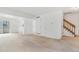 Open-concept living area with staircase and access to kitchen at 72 S Nome St, Aurora, CO 80012