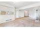 Open-concept living room with neutral carpet and access to the kitchen at 72 S Nome St, Aurora, CO 80012