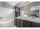 Bright bathroom featuring a tub, shower, dark vanity, and contemporary lighting at 10212 Kelliwood Way, Highlands Ranch, CO 80126