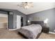 Bedroom showcases a large window, ceiling fan, and closet with open sliding doors at 10212 Kelliwood Way, Highlands Ranch, CO 80126