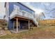 Exterior view of home's deck and backyard featuring a spacious grassy area at 10212 Kelliwood Way, Highlands Ranch, CO 80126