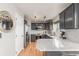 Modern kitchen with gray cabinets, stainless steel appliances, and light countertops at 10212 Kelliwood Way, Highlands Ranch, CO 80126