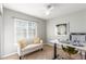 This home office features a light filled window and cozy seating at 10212 Kelliwood Way, Highlands Ranch, CO 80126