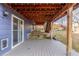 Outdoor entertaining space under a deck with string lights for ambiance in the backyard at 10212 Kelliwood Way, Highlands Ranch, CO 80126