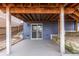 Covered patio space with sliding glass doors for easy access to indoor and outdoor living at 10212 Kelliwood Way, Highlands Ranch, CO 80126