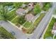 From above, the home features a pristine lawn and classic white picket fence with mature trees in a lovely neighborhood at 1691 Roslyn St, Denver, CO 80220