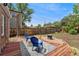 Inviting backyard with stylish seating area, wood deck, gravel accents, and partial privacy fence at 1691 Roslyn St, Denver, CO 80220