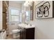 Cozy bathroom features a vanity sink, toilet, and shower-tub combination at 1691 Roslyn St, Denver, CO 80220