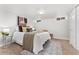 Relaxing bedroom featuring a queen bed with accent pillows, soft rug, and natural light from small windows at 1691 Roslyn St, Denver, CO 80220
