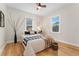 Cozy bedroom with hardwood floors, natural light, and neutral decor at 1691 Roslyn St, Denver, CO 80220