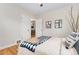 Bright bedroom featuring hardwood floors and neutral decor at 1691 Roslyn St, Denver, CO 80220