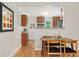 Inviting dining room flows into the kitchen, showcasing warm wood floors and a stylish design at 1691 Roslyn St, Denver, CO 80220