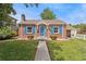 Charming brick home with bright blue door and shutters with grassy front lawn at 1691 Roslyn St, Denver, CO 80220
