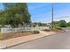 Charming brick home with bright blue door, shutters and white picket fence at 1691 Roslyn St, Denver, CO 80220