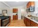 Spacious kitchen boasts stainless steel appliances, granite countertops, and wood floors at 1691 Roslyn St, Denver, CO 80220