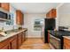 Bright kitchen featuring stainless steel appliances, granite countertops, and a window view at 1691 Roslyn St, Denver, CO 80220