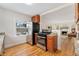 View of the kitchen with stainless steel appliances, opening to the living area at 1691 Roslyn St, Denver, CO 80220